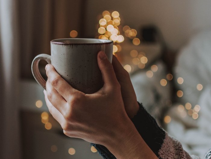 woman holding mug practicing self care