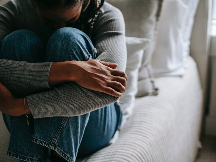 woman curled up depressed