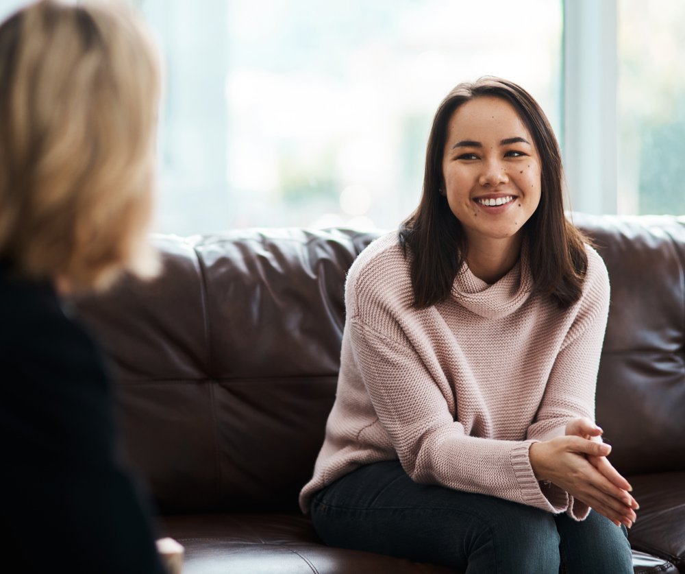 A young woman having a therapeutic session with a psychologist