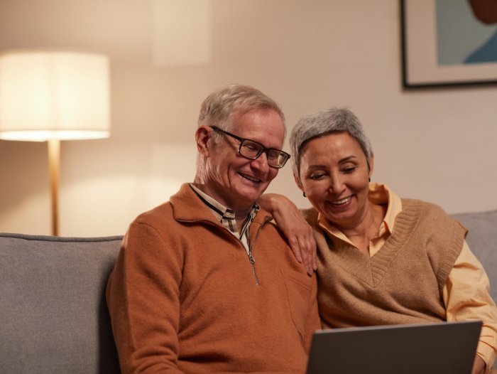 older people smiling at laptop