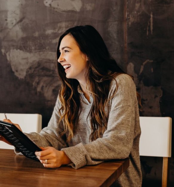 Woman laughing while on tablet