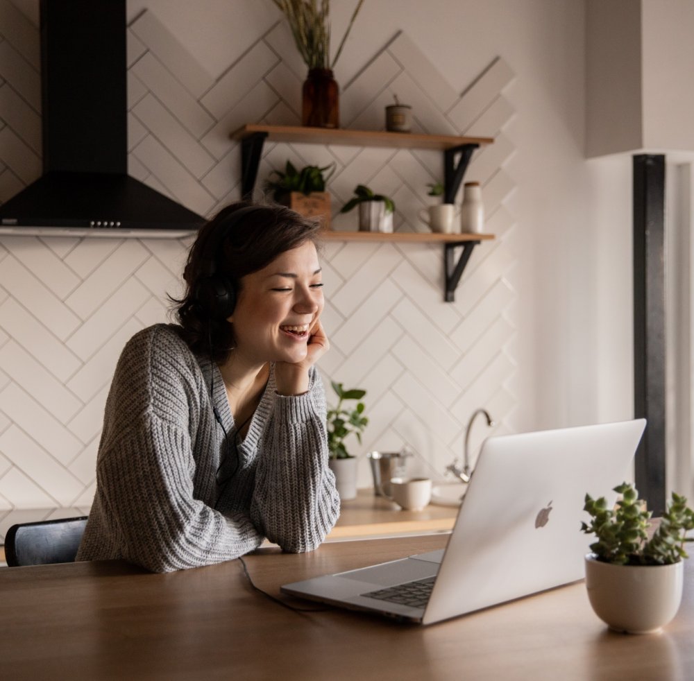 A client smiles while attending a telehealth appointment